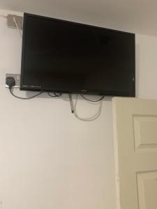 a flat screen tv hanging on a wall at The New Macleods Guest House in Blackpool