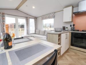 a kitchen and living room with a table and a couch at Giorgio in Preston