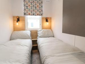 two beds in a small room with a window at Giorgio in Preston