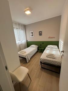 En eller flere senge i et værelse på PARCO VERDE APARTMENT