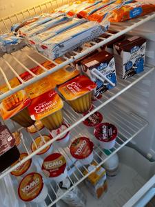 an open refrigerator filled with food and drinks at Fiera di Roma B&B in Ponte Galeria