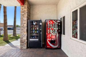 two vending machines are sitting next to a building at Super 8 by Wyndham Goodyear/Phoenix Area in Goodyear