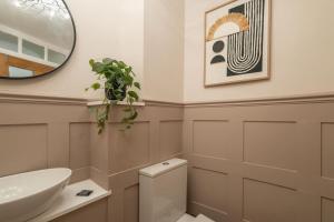 a bathroom with a sink and a toilet and a mirror at Host & Stay - Yule House in Alnwick +18 photos