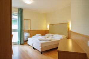 Łóżko lub łóżka w pokoju w obiekcie Club Hotel e Residence La Vela