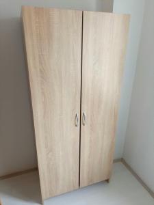 a wooden cabinet in a corner of a room at Historia Hostel in Skopje