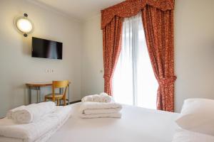 Łóżko lub łóżka w pokoju w obiekcie Club Hotel e Residence La Vela