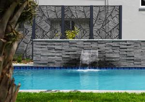 a swimming pool with a fountain in front of a building at TheLoft32 in Cape Town