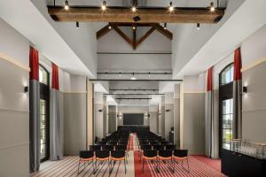 a hall with chairs and a stage in the middle at Hyatt Place Rouen in Rouen
