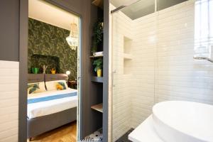 a bathroom with a shower and a sink and a bed at Parco Vittadini Apartment in Milan +60 photos
