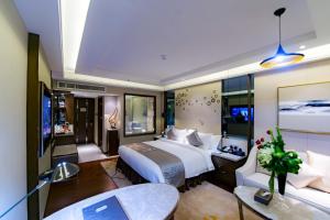 a hotel room with a bed and a couch at Braira Al Olaya in Riyadh