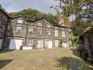 a large brick building with white doors and windows at The Mounting Steps in Ambleside