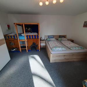 a bedroom with two beds and a bunk bed at Ferienwohnung Hof Postel in Hemmoor +32 photos