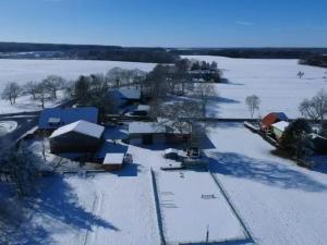 an aerial view of a farm in the snow at Ferienwohnung Hof Postel in Hemmoor