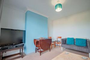 a living room with a couch and a television at Host & Stay - Lechlade in Birmingham