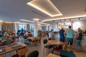 a group of people standing in a restaurant at Hotel Dior in Krujë