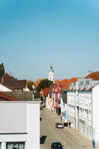 a view of a street with buildings and a lighthouse at Sedan Apartments - Central Stay near LEGOLAND with Free Parking in Günzburg