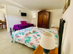 a bedroom with a bed with a lamp and a chair at Mandorlo Barocco in Noto