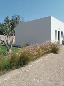 a white building with a billboard on the side of it at Charmante maison indépendante in Oulad el Madani