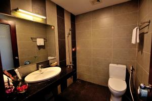 a bathroom with a sink and a toilet and a mirror at Dong Xanh Hotel in Chau Doc +15 photos