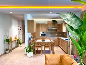 a kitchen with wooden cabinets and a table with chairs at AARU Maadi Luxe Retreat in Cairo