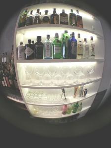 a refrigerator filled with lots of bottles and glasses at Hostal Fisterra in Lugo