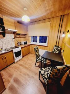 a kitchen with a table and chairs in a room at Harku Lake Apartment in Tallinn