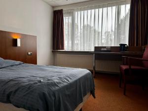 Postel nebo postele na pokoji v ubytování Hotel De hertog Franeker