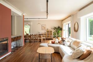a living room with a couch and a table at Villa Nestor in Sint-Idesbald