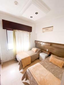 Voodi või voodid majutusasutuse Hotel Lujan toas
