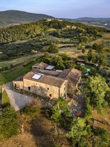 an aerial view of an old building in a field at La Pieve di San Giovanni Luxury Retreat & Spa in Lustignano