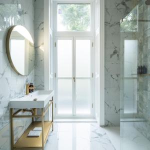 a bathroom with a sink and a mirror at Ellen Kensington in London +38 photos