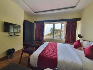 a hotel room with a bed and a window at Hotel Jemvalley in Kodaikānāl +42 photos
