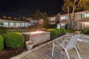 two chairs and a fire pit in a yard at night at Meadowmere Resort in Ogunquit