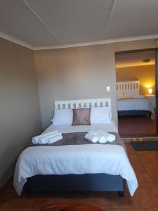 a bedroom with a large bed with two towels on it at Breakers Edge in Bay View