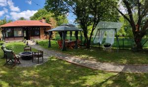 a backyard with a gazebo and a playground at Apartment Buga Bilje in Bilje