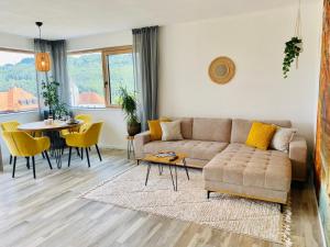 a living room with a couch and a table at Luxury Mountain Lodge in Füssen
