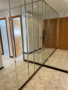 a large glass wall in a room with doors at Habitación Matrimonio Tranquila en Vivienda Compartida in Valencia +20 photos