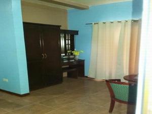 a living room with a table and a cabinet at Ucoy Beach Resort in Libertad