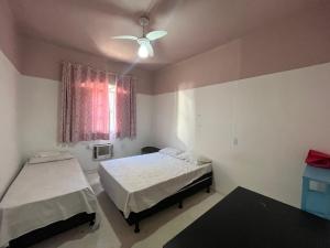 a bedroom with two beds and a ceiling fan at LiveRio Hostel Ipanema in Rio de Janeiro