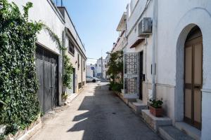 an alley with buildings and a gate and a street at Tina House & Parking by BarbarHouse in Bari