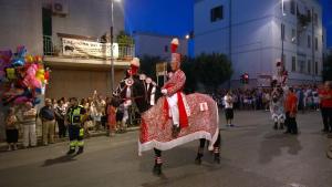 a man is riding a horse in a parade at I Cieli Di Ostuni in Ostuni