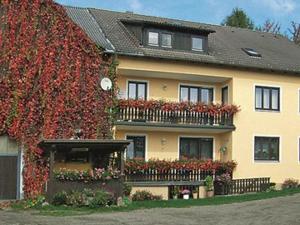 a house with flowers on the side of it at Ferien auf dem Bauernhof in Moosbach
