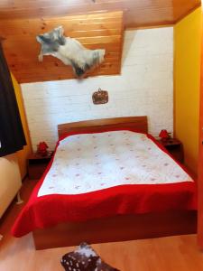 a bedroom with a bed and two cow statues on the wall at Colt de rai in Bran +26 photos