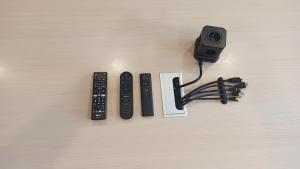three remote controls and a camera on a table at Rez de jardin & Salle de réunion in La Ferrière +28 photos