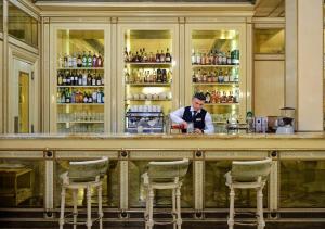 a man standing behind a bar in a restaurant at Hotel Bristol in Odesa