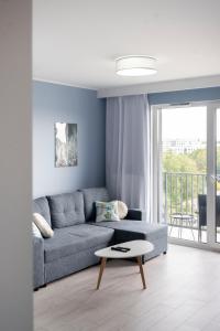 a living room with a couch and a table at Apartament Morski by GoApart in Gdańsk
