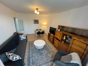 a living room with a couch and a table at Apart´ Coco in Luduş
