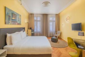 Televízia a/alebo spoločenská miestnosť v ubytovaní Casati Hotel - Adults Only
