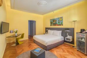 A bed or beds in a room at Casati Hotel - Adults Only