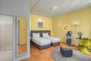 A bed or beds in a room at Casati Hotel - Adults Only
